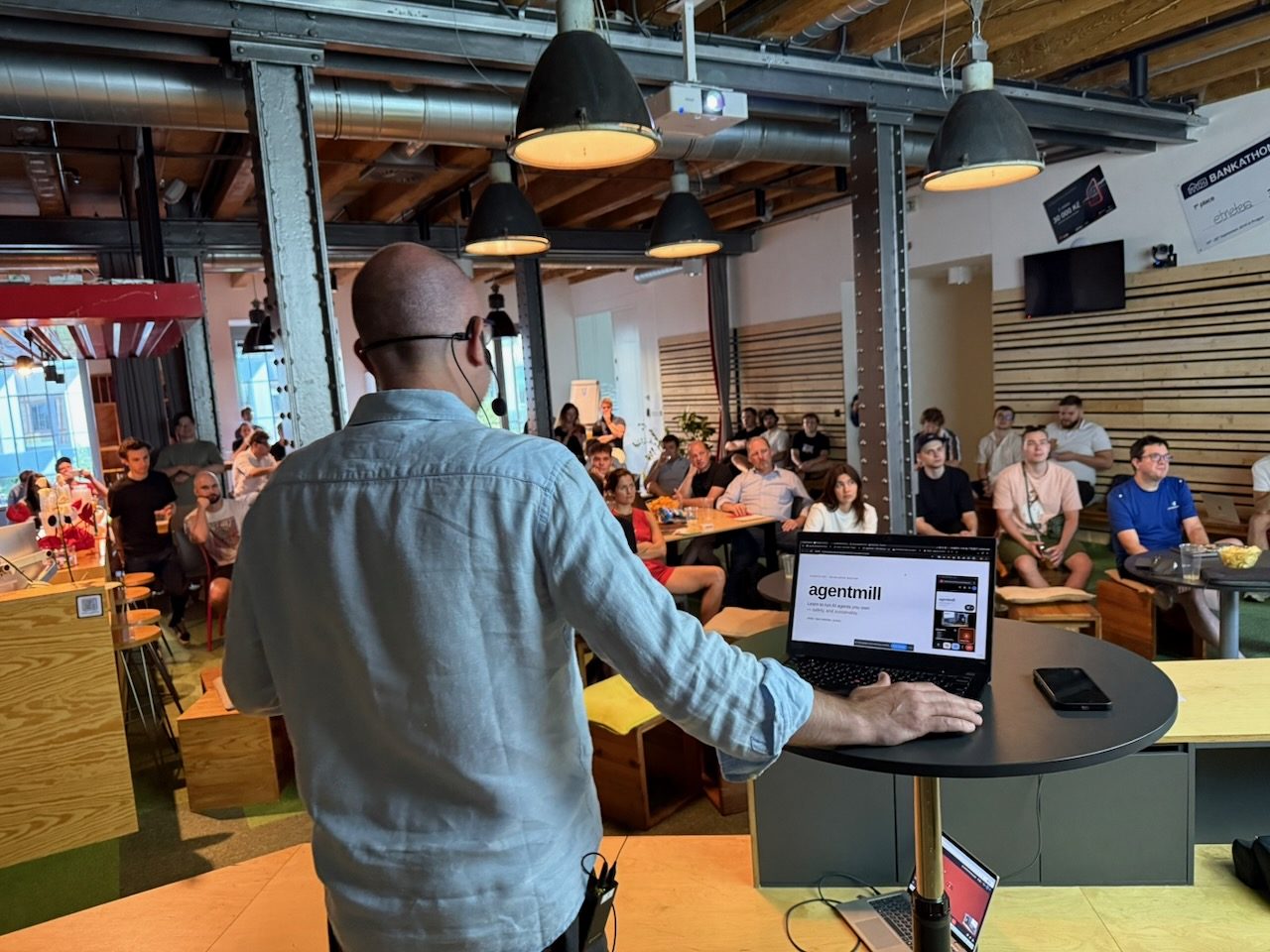 Presenter facing the crowd from the laptop stand